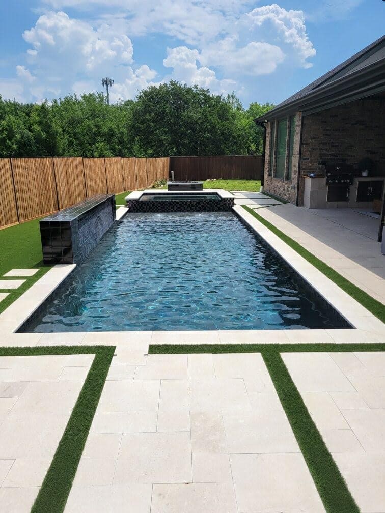 Modern pool with raised spillover spa