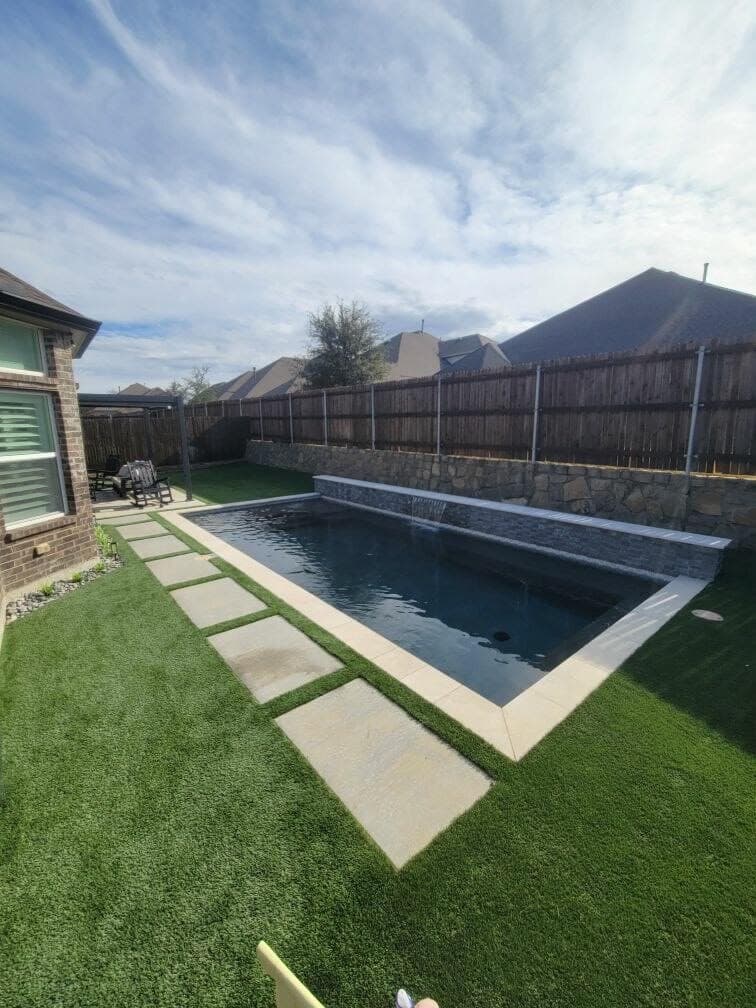 Custom gunite pool with stone water wall